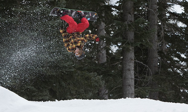 Army National Guard Spc. Charity McGeary, a combat medic with the 856th Military Police Company, does a backflip on her snowboard at Arizona Snowbowl in Flagstaff, Arizona. About 20 percent of skiing or snowboarding injuries are head injuries. (U.S. Army photo by Staff Sgt. Brian Barbour)