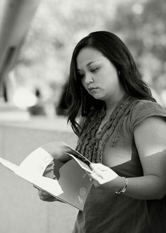 Young woman reading health information about lupus