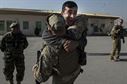 An Afghan air force member jumps into the arms of U.S Air Force Master Sgt. Daniel Prosymchak near Forward Operating Base Oqab, Kabul, Afghanistan, Dec. 13, 2015. Prosymchak is assigned to the Train, Advise, Assist Command-Air security forces and is deployed from Joint Base Charleston, S.C. (U.S. Air Force photo/Staff Sgt. Corey Hook) 
