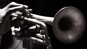 Close up of hand playing a trumpet