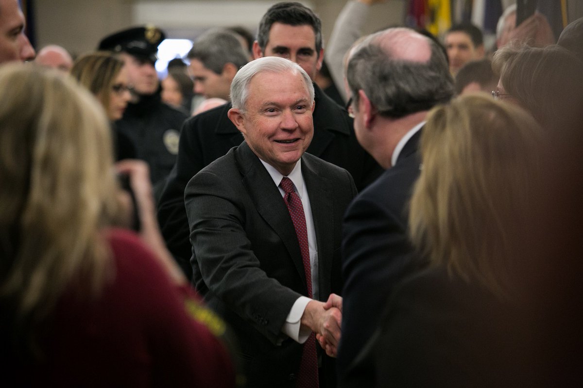Attorney General Jeff Sessions greets Department of Justice employees as he arrives at the department.