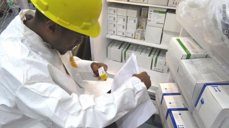 A warehouse staffer checks new stock of life-saving drugs for Guyana’s HIV/AIDS population. 