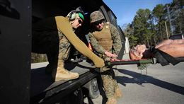 Corpsmen transport a notional patient onto an aircraft during a Tactical Combat Casualty Care training exercise at Marine Corps Base Camp Lejeune, North Carolina, Feb. 6-10, 2017. The TCCC teaches corpsmen new communication skills and how to care for a patient in a combat zone. The corpsmen are with 2nd Medical Battalion. 