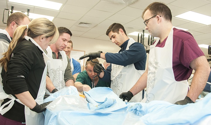 Soldiers with Army Trauma Training Center’s Combat Extremity Surgery Course prepare a cadaver limb for placement of an external fixator. (U.S. Army photo by Marcy Sanchez)