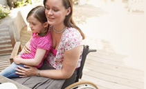 photo of woman in a wheelchair with child on her lap