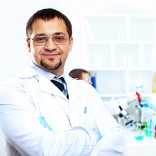 A male researcher stands in his lab
