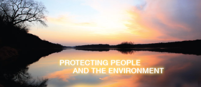 A sundown scene of a lake with the sun setting behind the trees and the words Protecting People and the Enivronment