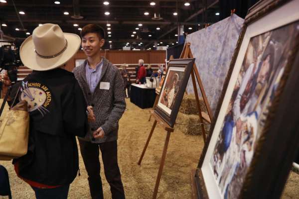 Andy Wei is congratulated after being awarded Grand Champion for 'Timeless' at the ﻿Livestock and Rodeo School Art Program.﻿