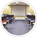 computer classroom with computer stations and presentation screen