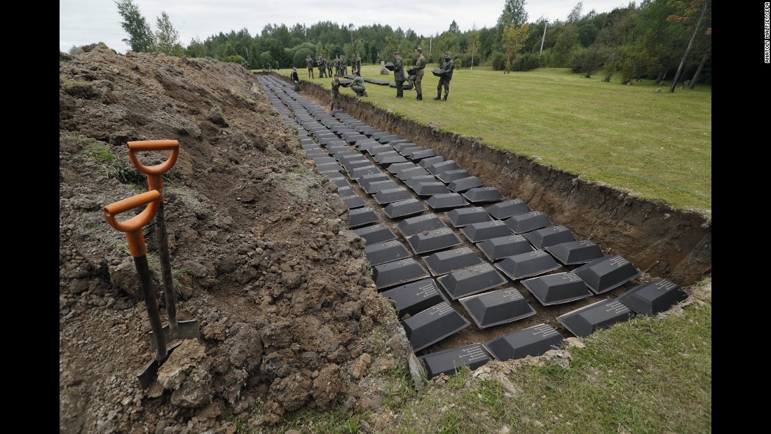 German and Russian soldiers take part in a reburial ceremony Wednesday, September 6, for hundreds of German soldiers who were killed during World War II. The remains were found in Russia&#39;s Leningrad region and reburied at a cemetery in Sologubovka, Russia.