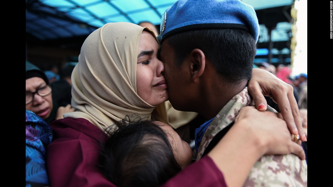 Mohd Farhan, a member of the Malaysian armed forces, hugs his wife Siti Salwa on Thursday, September 7, before leaving for Lebanon. Malaysia sent about 850 troops to Lebanon to take part in UN peacekeeping activities.