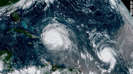 In this GOES-16 geocolor image satellite image taken Thursday, Sept. 7, 2017, the eye of Hurricane Irma, left, is just north of the island of Hispaniola, with Hurricane Jose, right, in the Atlantic Ocean. Irma, a fearsome Category 5 storm, cut a path of devastation across the northern Caribbean, leaving at least 10 dead and thousands homeless after destroying buildings and uprooting trees on a track Thursday that could lead to a catastrophic strike on Florida. (NOAA via AP)