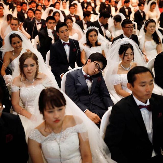 A groom naps as newlywed couples attend a mass wedding ceremony of the Unification Church at Cheongshim Peace World Centre in Gapyeong, South Korea, September 7, 2017.  REUTERS/Kim Hong-Ji #wedding #marriage #reuters #reutersphotos #southkorea #masswedding