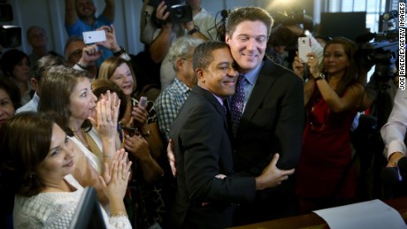 Newlyweds Jeff  and Todd Delmay hug during a marriage ceremony in a Miami-Dade court room. Florida began allowing same-sex marriages after a judge -- following similar rulings across the nation -- struck down the state&#39;s old law banning such unions.