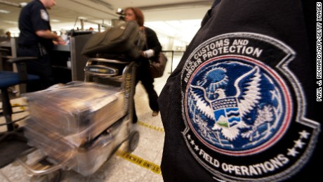 An international air traveler is cleared by a US Customs and Border Protection Officer (L) and is approved to enter the United States inside the US Customs and Immigration area at Dulles International Airport (IAD) , December 21, 2011 in Sterling, Virgina, near Washington, DC.     AFP Photo/Paul J. Richards (Photo credit should read PAUL J. RICHARDS/AFP/Getty Images)