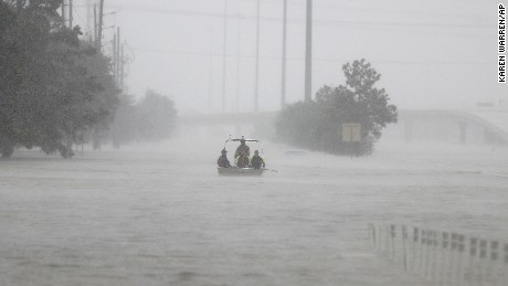 Members of the Texas Border Patrol bring their boat back to the launch site near Deerbrook Mall, on FM 1960, after currents were too rough to transport an elderly woman, needing rescue from behind the mall, as heavy rains continued falling from Tropical Storm Harvey, Tuesday, Aug. 29, 2017, in Humble, Texas. (Karen Warren/Houston Chronicle via AP)