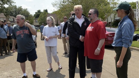 President Donald Trump and First Lady Melania Trump stop to talk with residents impacted by Hurricane Harvey in a Houston neighborhood on September 2.