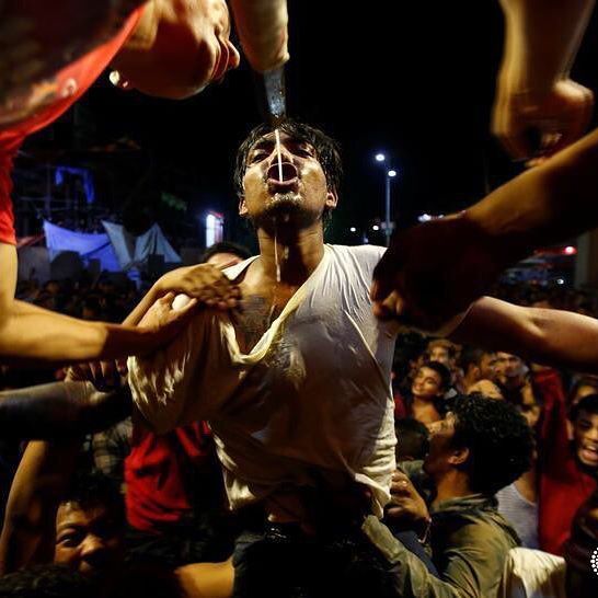 A youth struggles to drink homemade alcohol poured from the mouth of an idol of Sweaita Bhairab during the annual Indra Jatra festival to worship Indra, Kumari and other deities and to mark the end of monsoon season in Kathmandu, Nepal September 4, 2017. REUTERS/Navesh Chitrakar #reuters #reutersphotos #nepal #religion #festival