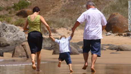 Family running on beach; Shutterstock ID 8850394