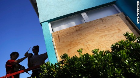 Paulita Kundid, left and her brother Mike Kundid board up their apartment building ahead of Hurricane Irma in Daytona Beach, Fla., Friday, Sept. 8, 2017. Coastal residents around South Florida have been ordered to evacuate as the killer storm closes in on the peninsula for what could be a catastrophic blow this weekend. (AP Photo/David Goldman)