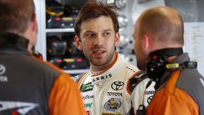 Daniel Suarez, of Mexico, talks with crew members after practice for the NASCAR Cup Series auto race in Brooklyn, Mich., Saturday, Aug. 12, 2017. (AP Photo/Paul Sancya)