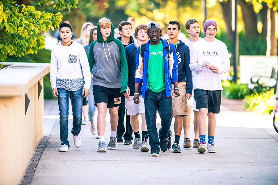 Male students walking in UNT Library Mall