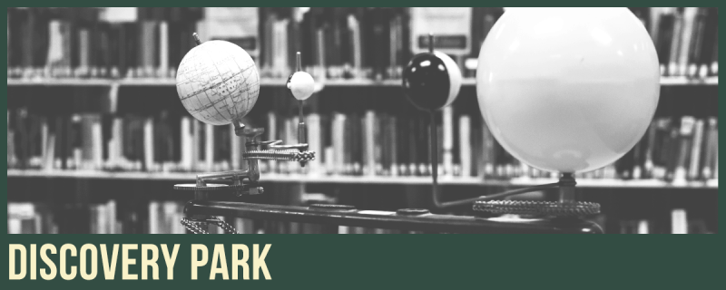 science tools surrounded by books in the stacks