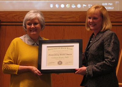 Colleen Swain holding award with Jurhee Curtis