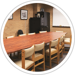 conference room with table, chairs, file cabinets, and dry erase board