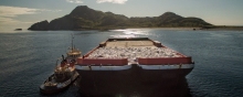 A barge carrying many bags of debris.