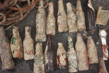 Glass bottles encrusted with sediment.