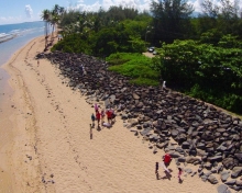 Volunteers picking up debris from a Caribbean beach.