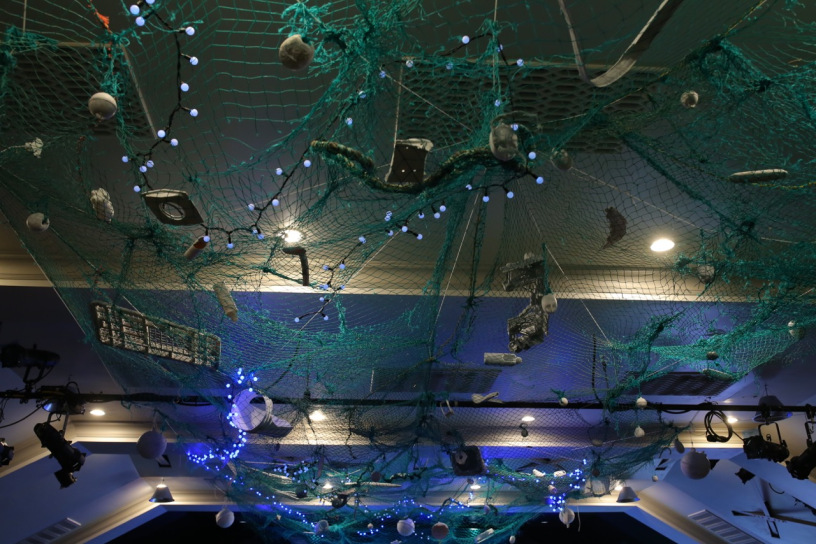 Marine debris art hanging from the ceiling.