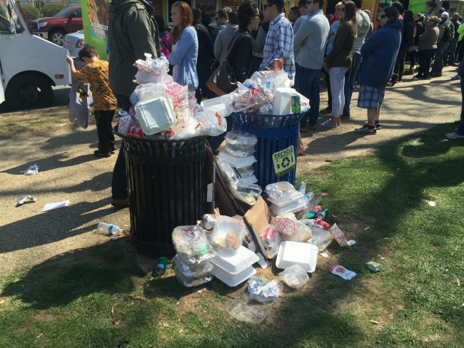 An overflowing trash can.