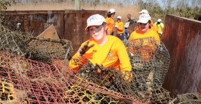 Volunteers fill a container with derelict crab traps collected during a "Derelict Crab Trap Rodeo" in 2014. (Photo Credit: Louisiana Sea Grant)