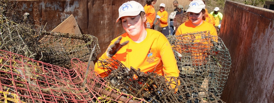 Volunteers fill a container with derelict crab traps collected during a "Derelict Crab Trap Rodeo" in 2014. (Photo Credit: Louisiana Sea Grant)