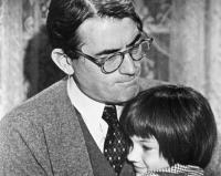 Still from the movie To Kill a Mockinbird showing Atticus and Scout