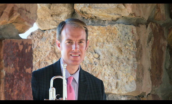 Marc Reed seated with trumpet