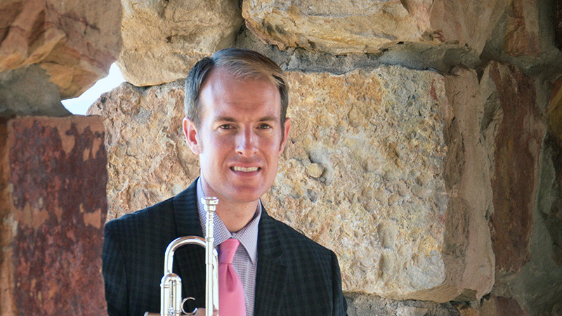 Marc Reed seated with trumpet