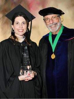 Suzanne Smith and Dr. Sinclair in front of a tan background