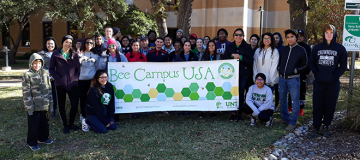 students holding bee campus usa sign