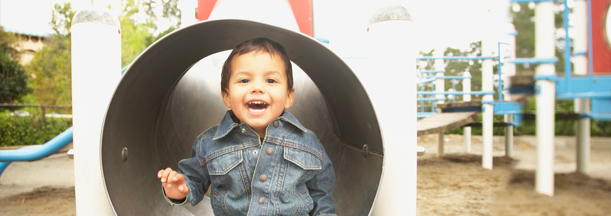 Native American boy playing in tunnel