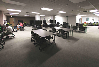 gaming commons area with tables and chairs