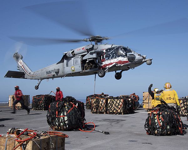 An MH-60S Seahawk attached to Helicopter Sea Combat Squadron (HSC) 21 prepares to lift ordnance from the flight deck of amphibious assault ship USS Boxer (LHD 4). Boxer is conducting routine operations in the eastern Pacific.  U.S. Navy photo by Mass Communication Specialist 2nd Class Dale M. Hopkins (Released)  200505-N-IQ884-1195