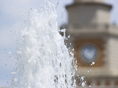 fountain with clock tower in the background