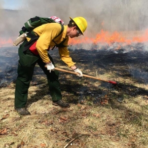 AmeriCorps NCCC member making fire line