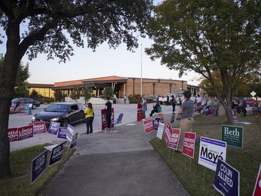 Supporters of various candidates greet voters outside a polling place at Fretz Park Branch Library on Election Day, Tuesday, Nov. 3, 2020, in Dallas. (Smiley N. Pool/The Dallas Morning News)