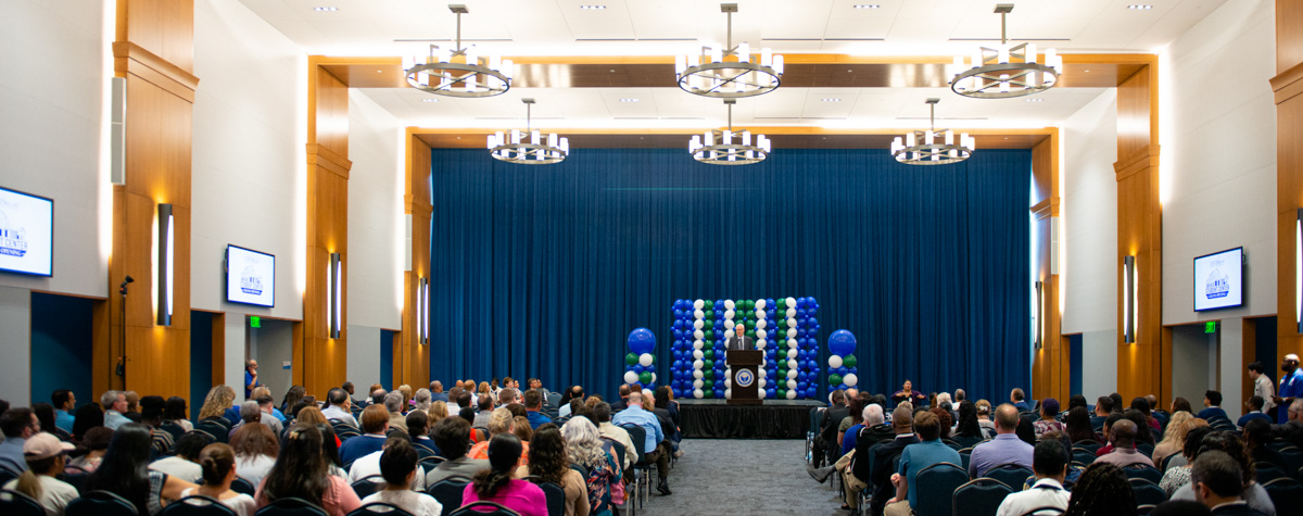 wide shot of campus hall full of people