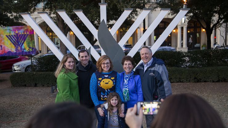 Families take a photo at the Chabad of Frisco’s 2019 menorah lighting. This year’s event, honoring health workers, includes COVID-19 precautions such as social distancing.