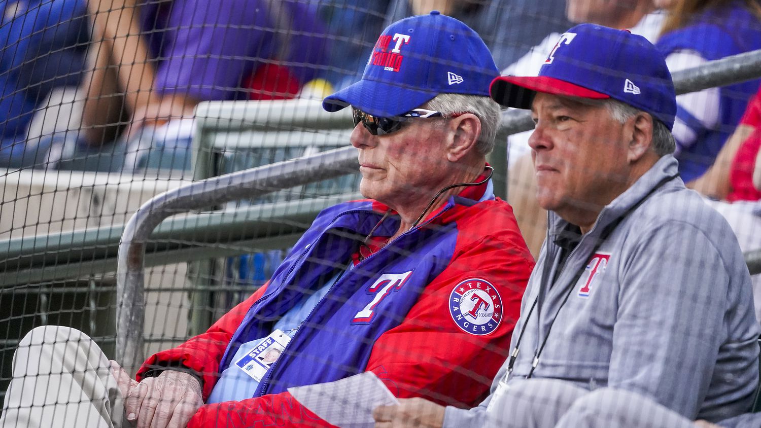 Texas Rangers co-chairman and managing partner Ray C. Davis (left) and chairman, ownership committee and chief operating officer Neil Leibman watch during the third inning of a spring training game against the Chicago Cubs at Surprise Stadium on Thursday, Feb. 27, 2020, in Surprise, Ariz.